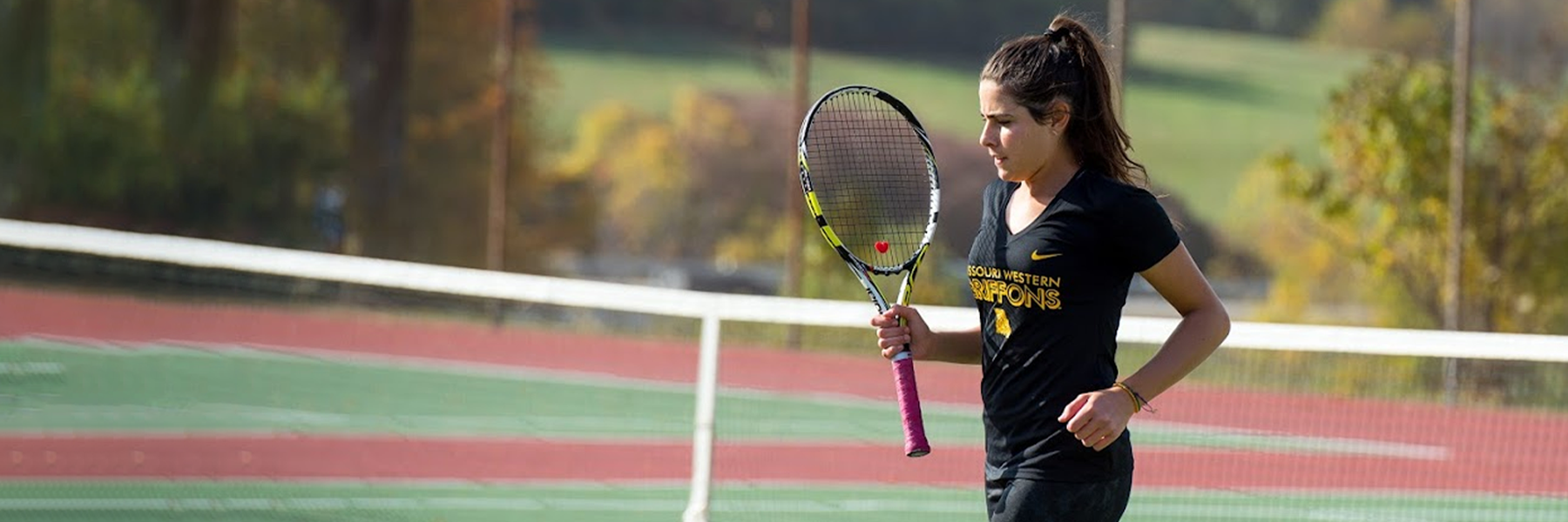 a student holding a tennis racket
