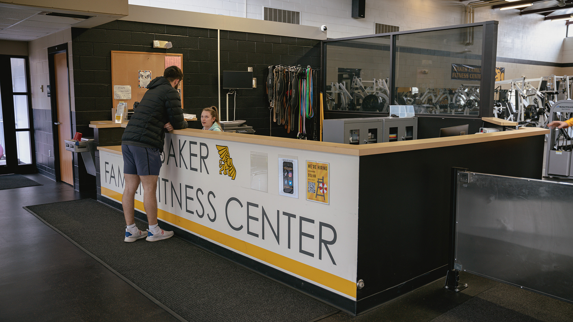 Student at front desk of Baker fitness center