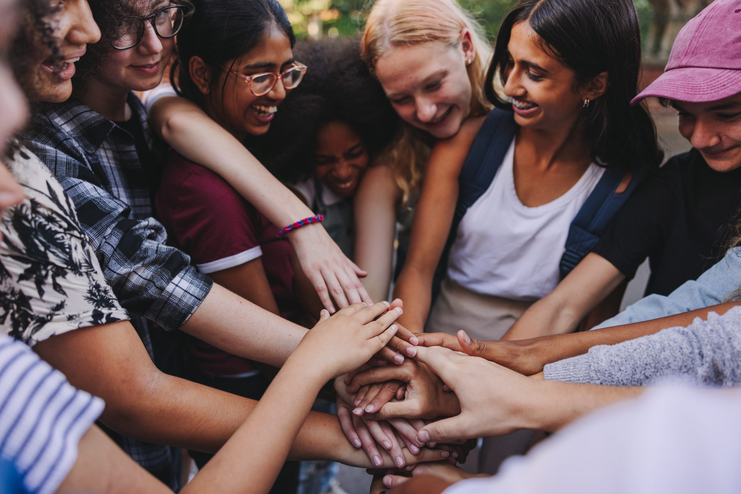 Many hands stacked together