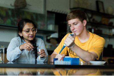 Biology student looking in microscope