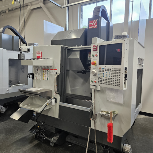 A CNC machine sits in a large room.