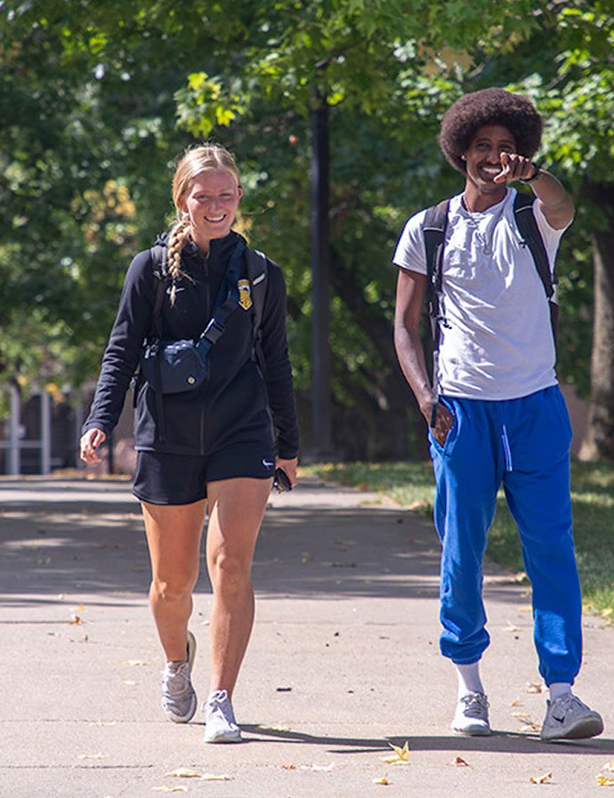 Students walking on sidewalk on campus
