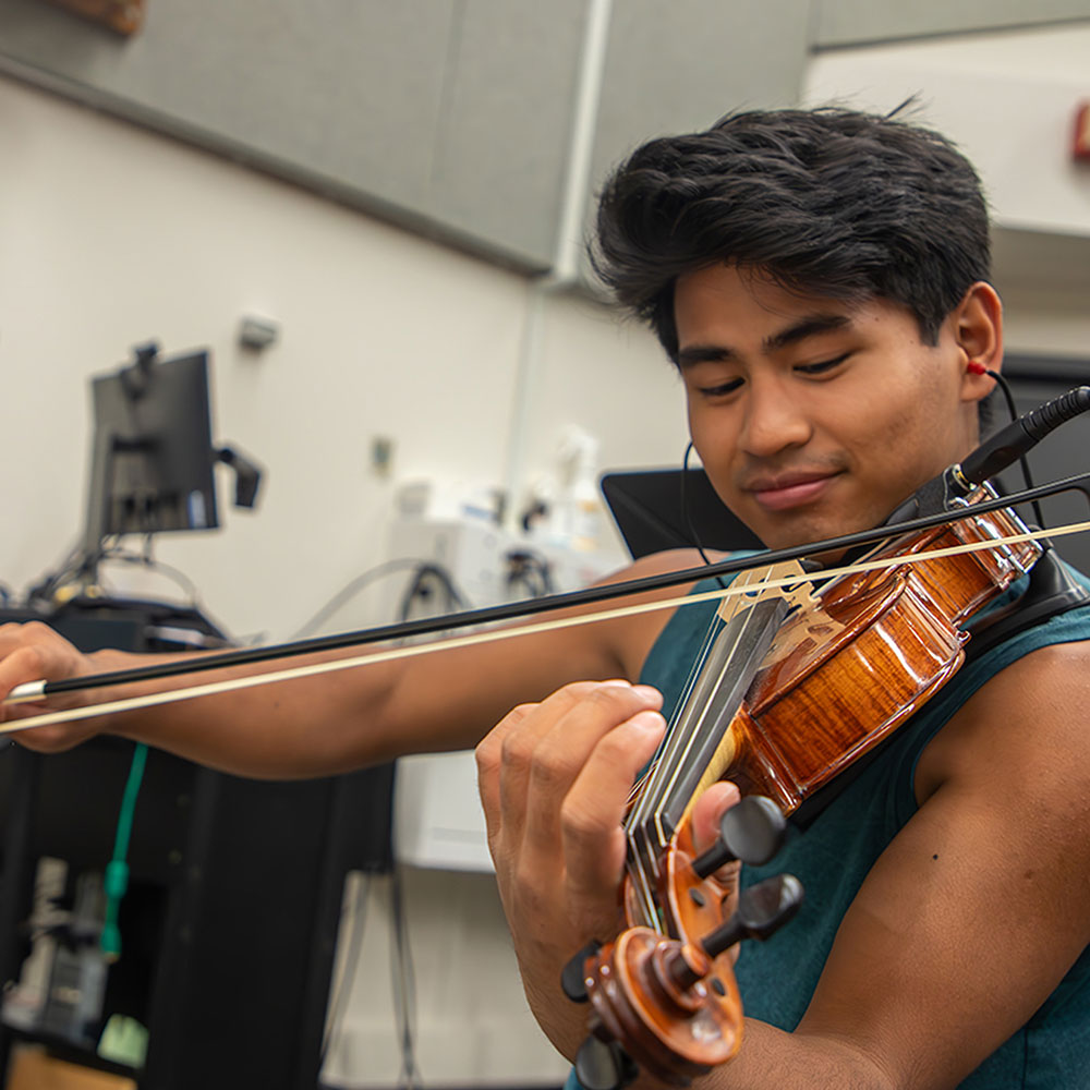 Student playing a violin