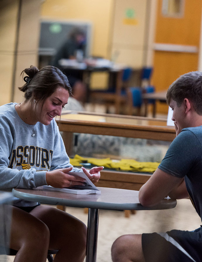 Two students studying at a lunch table