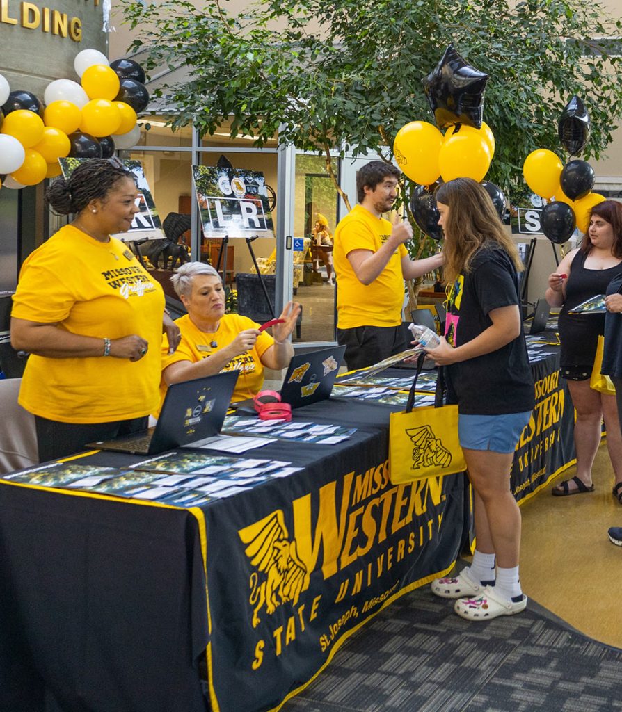 Students outside at a table event