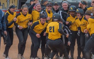 Griffons celebrate at home plate as Lonnie Groves runs makes her final step into home