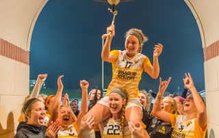 The Griffons celebrate at the victory bell